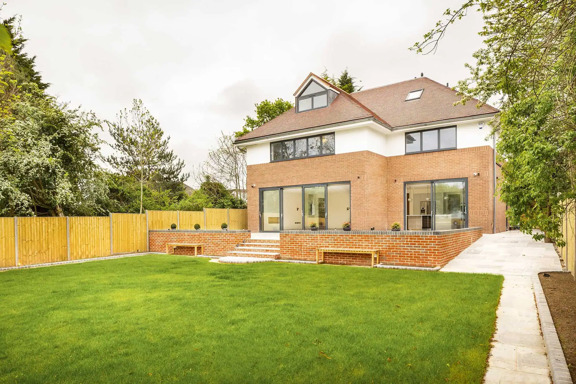 Luxury new build home in Belsize Park with modern architecture, landscaped garden, and spacious outdoor area.